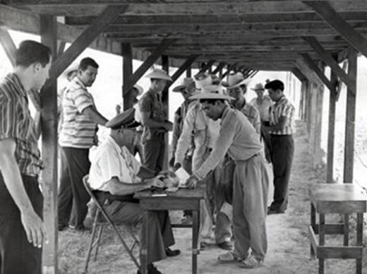 Immigrant Inspector inspecting Braceros for admission, Hidalgo, Texas, 1957